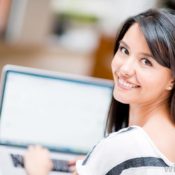 woman_looking_over_shoulder_at_computer-99t5764